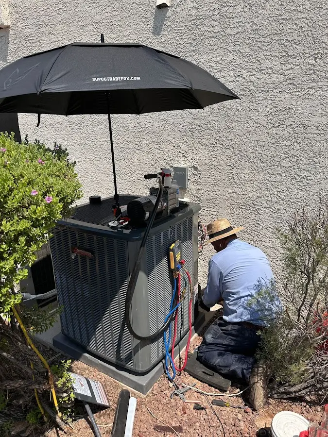 HVAC technician performing outdoor AC maintenance in Dale City